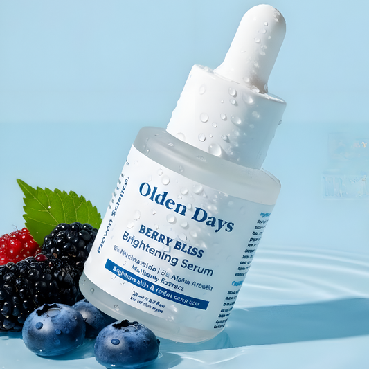 Bottle of Olden Days Berry Bliss Brightening Serum with berries on a light blue background