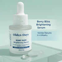 Bottle of Olden Days Berry Bliss Brightening Serum with berries on a light green background